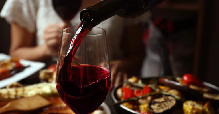 Wine service training - Professional sommelier presenting and serving wine